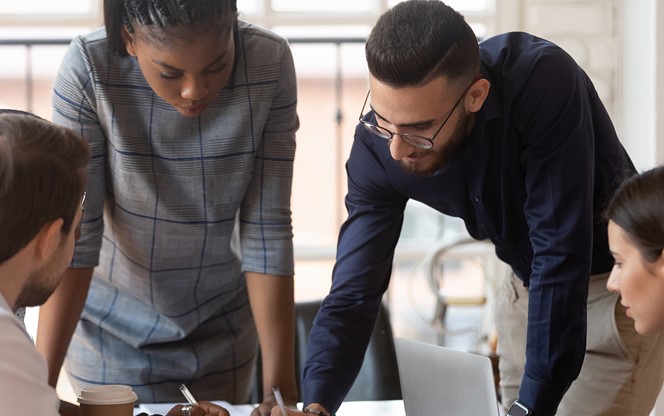 Focused Multiracial Corporate Business Team People Brainstorm On Paperwork