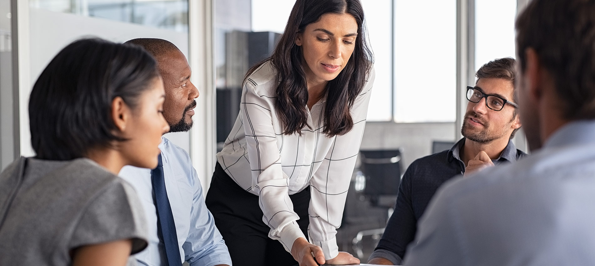 Businesswoman With Business Team In Conference Room Discussing