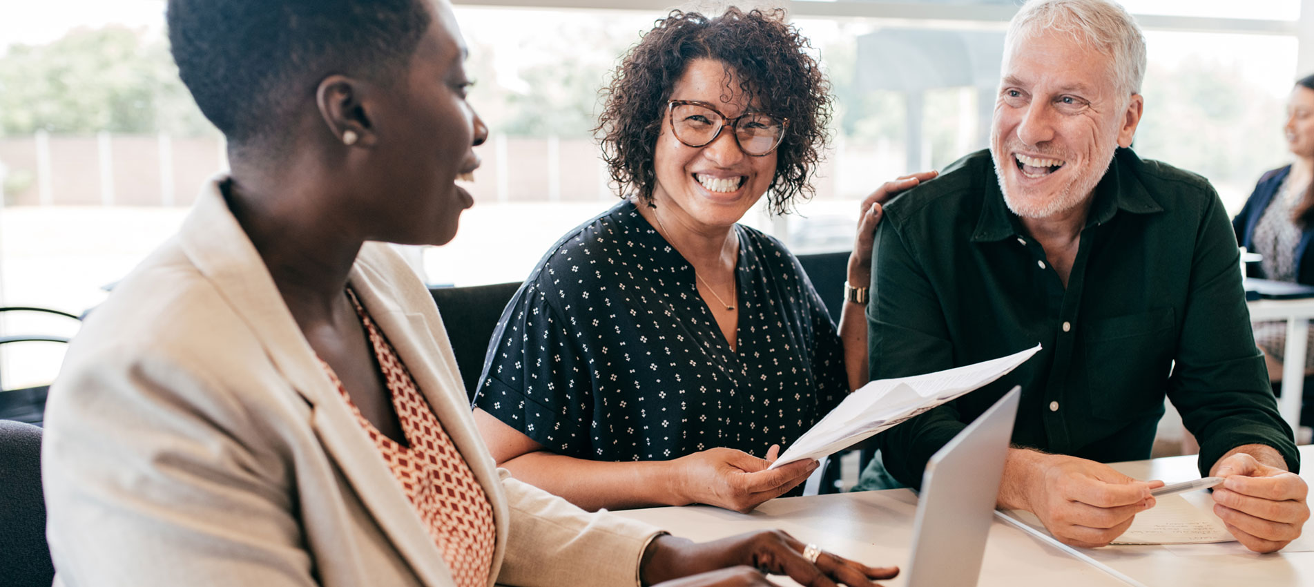 Three People At A Meeting Smiling