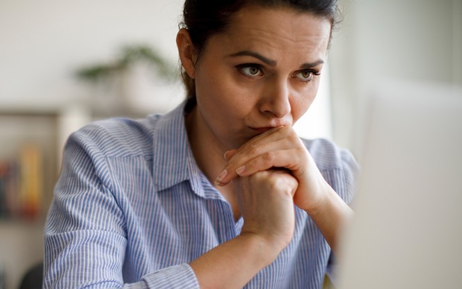 Worried Woman Looking At Computer Screen