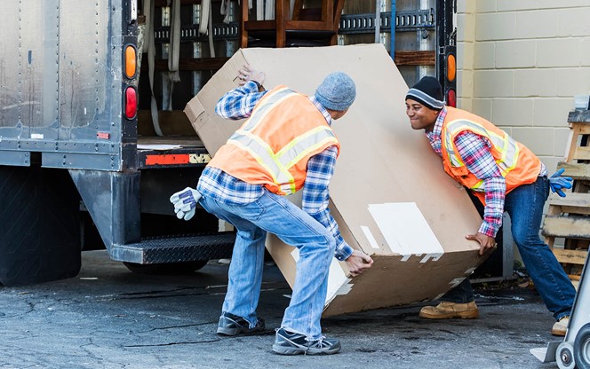 Workers Moving Large Box