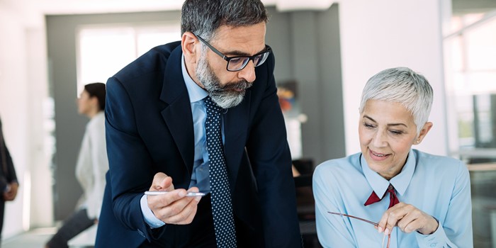 Mature Businessman And Businesswoman Planning In Office