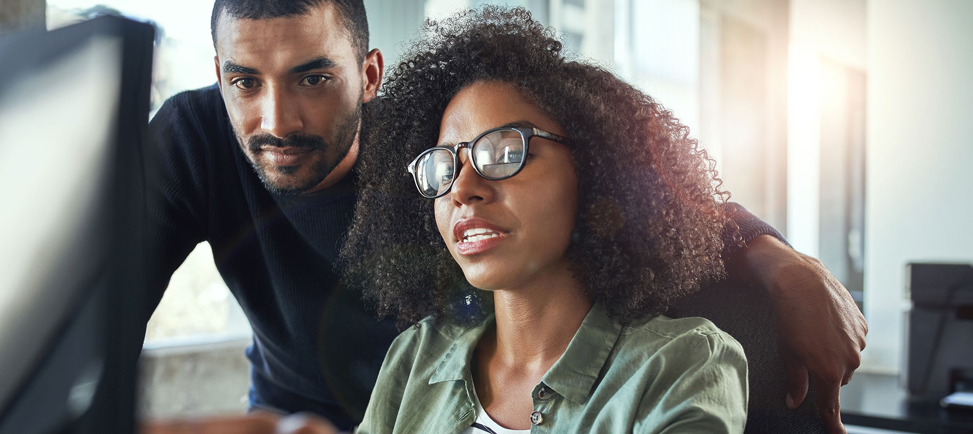 Two Business Colleagues Working Together In Office