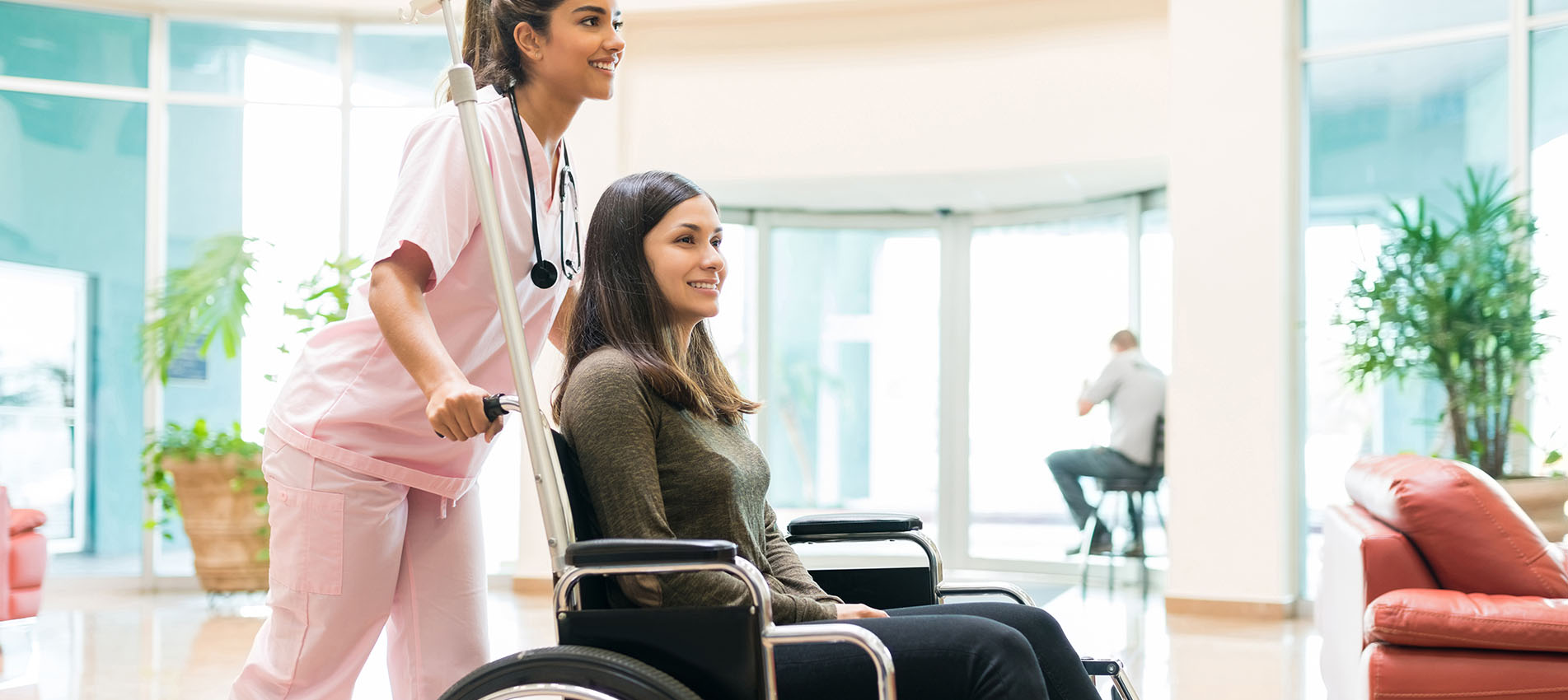 Nurse Assisting Patient In Wheelchair