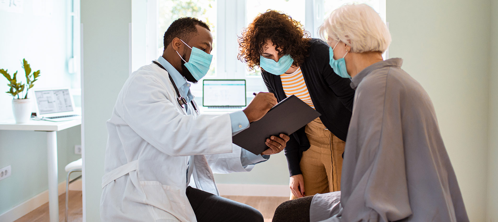 Senior Woman And Her Daughter Having A Doctors Appointment