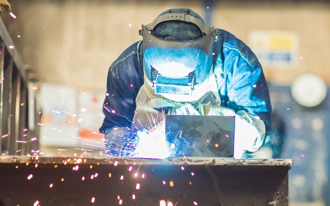 Steel Factory Worker Working On Iron