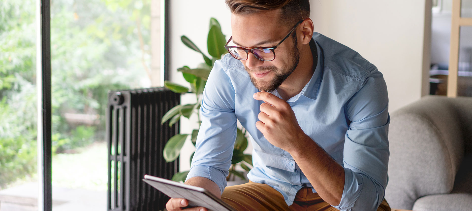 Young Man Looking At Digital Tablet