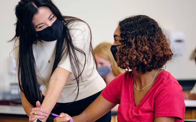 High School Teacher And Students In Classroom Wearing Protective Face Mask
