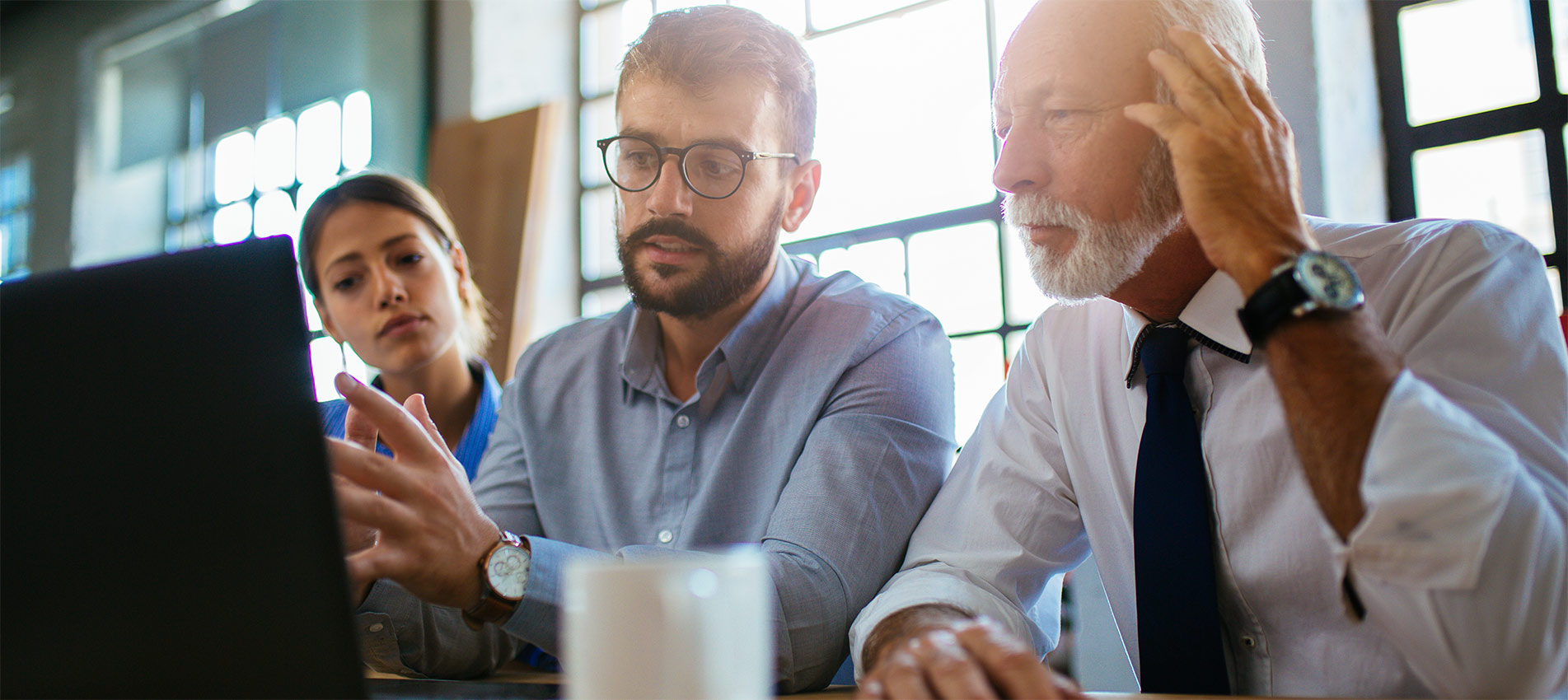 Three Business People Having A Meeting At The Modern Office