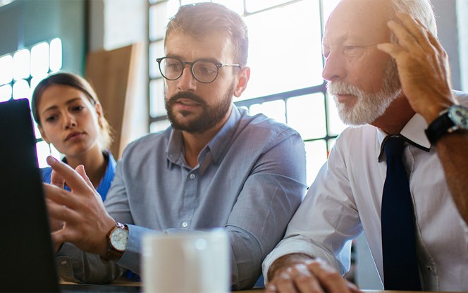 Three Business People Having A Meeting At The Modern Office