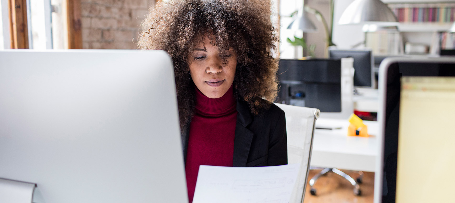 Creative Businesswoman Working In The Office Reading A Document