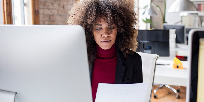 Creative Businesswoman Working In The Office Reading A Document