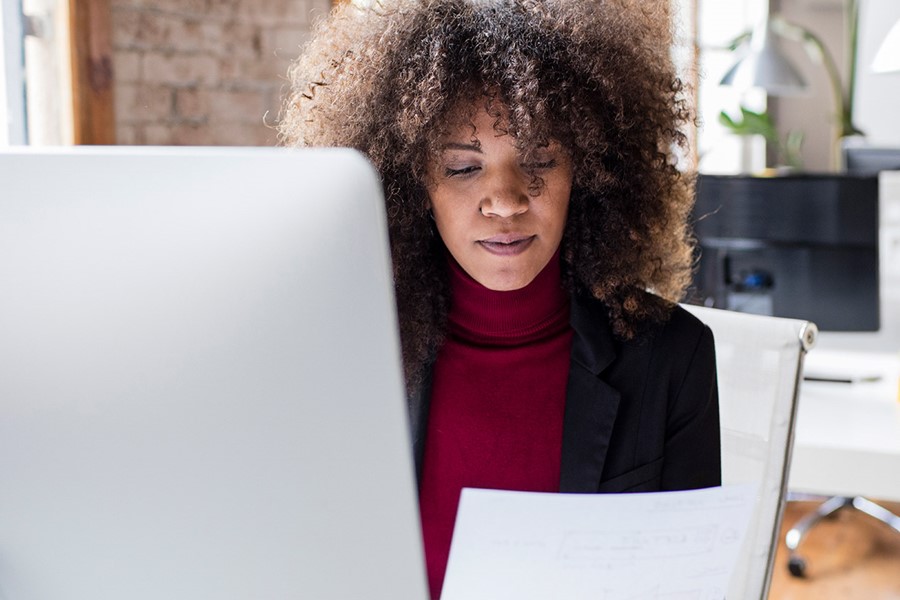 Creative Businesswoman Working In The Office Reading A Document