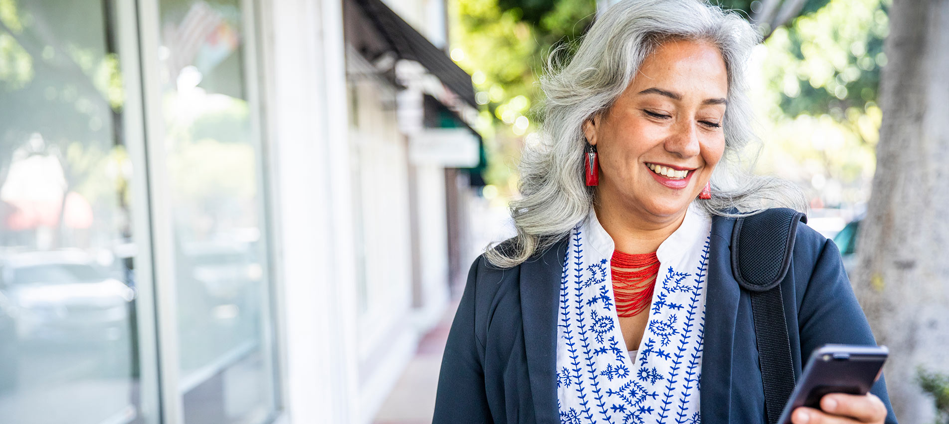 Mature Mexican Businesswoman Texting On Her Phone