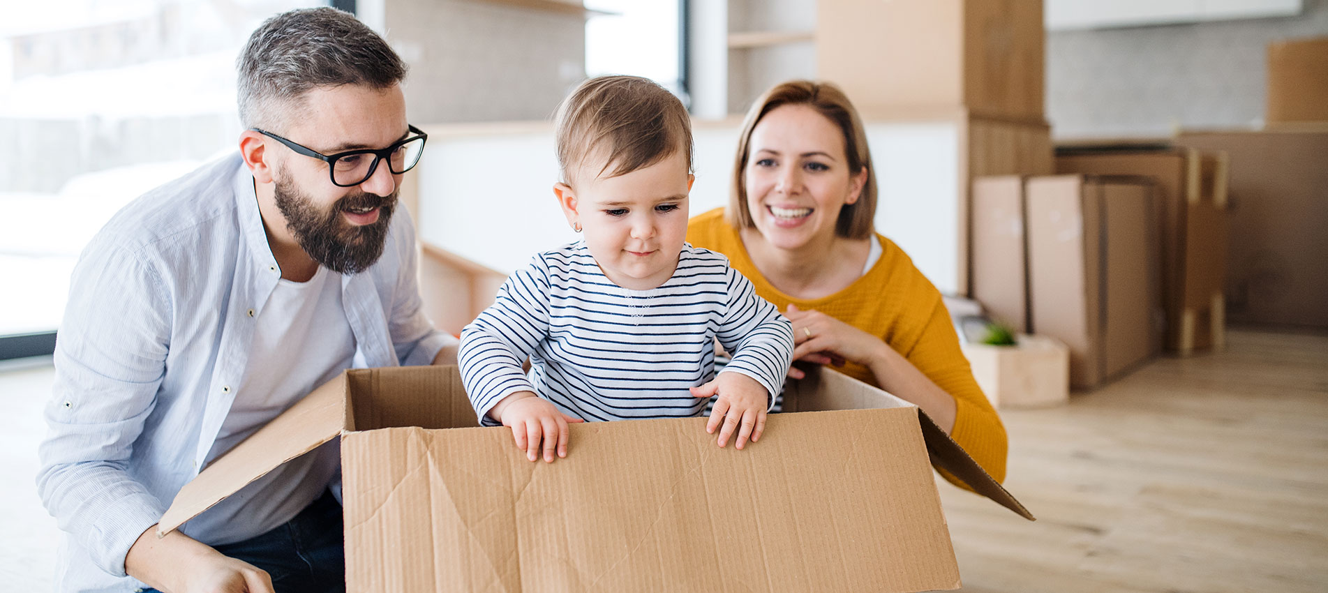 Young Family With A Toddler Girl Moving In New Home