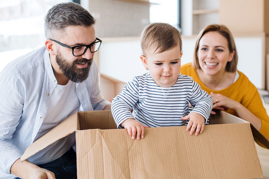 Young Family With A Toddler Girl Moving In New Home