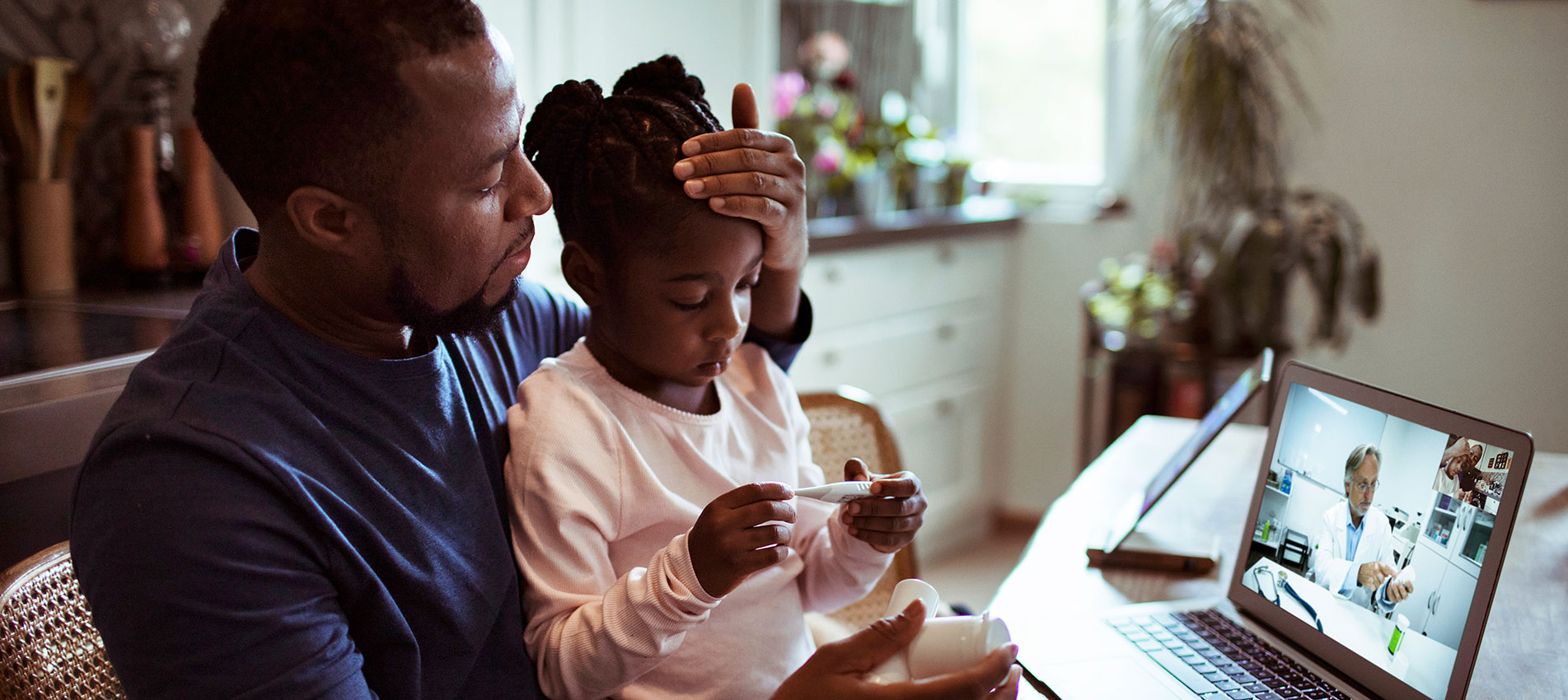 Father And Daughter Having A Video Call With Their Doctor
