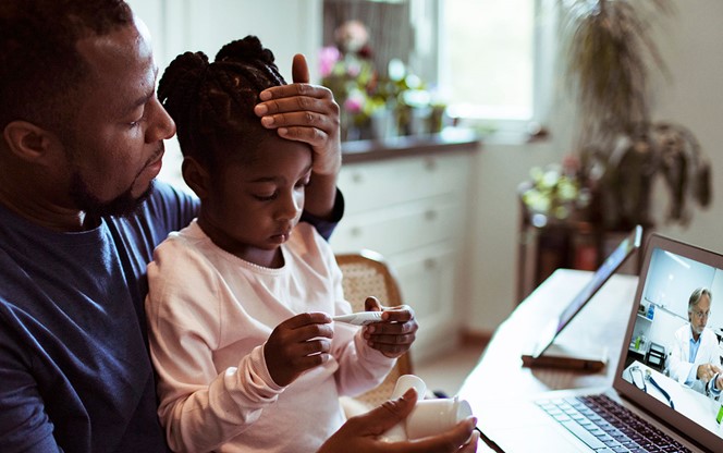 Father And Daughter Having A Video Call With Their Doctor