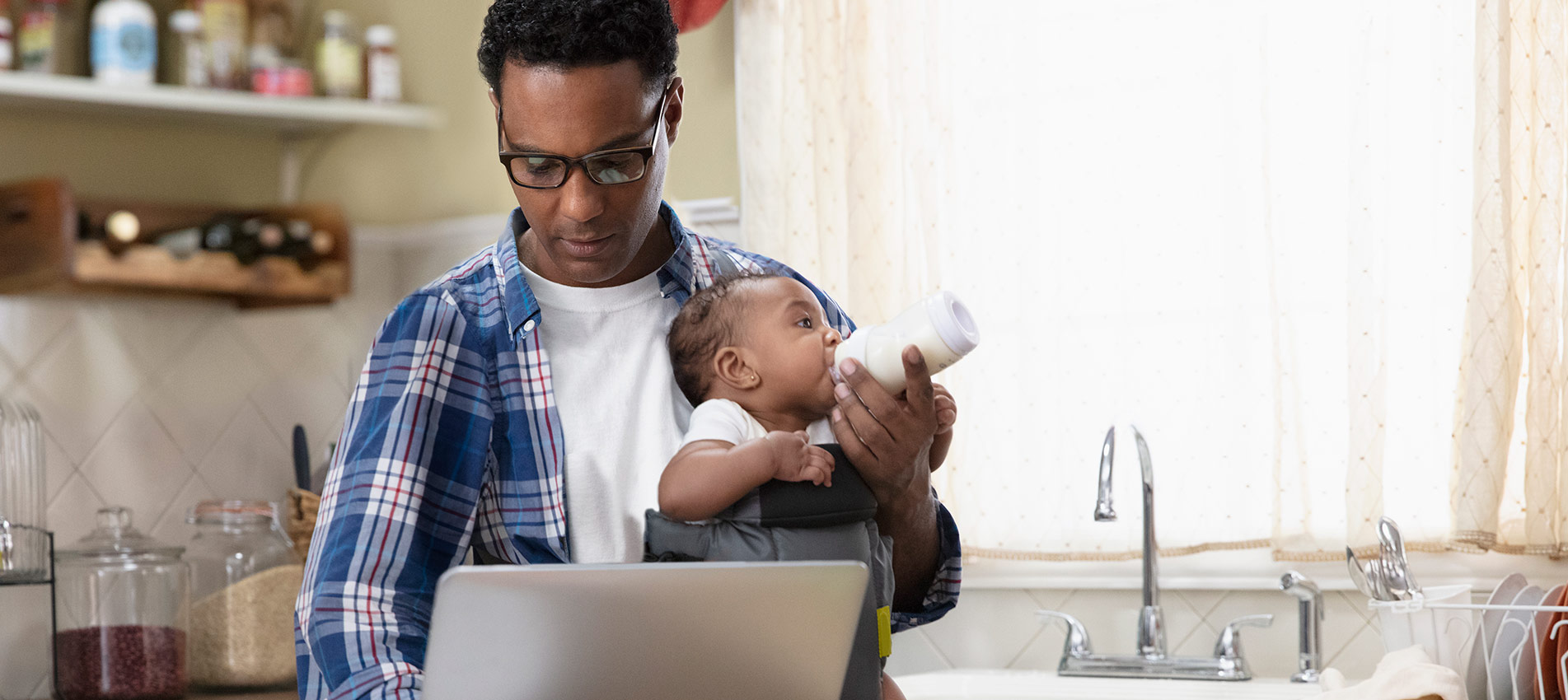 Father Working From Home Holding Baby