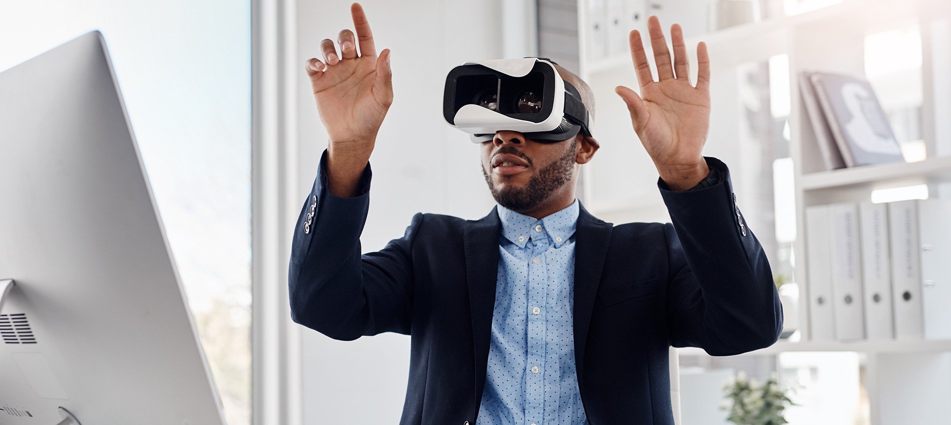 Young Businessman Wearing A Virtual Reality Headset At His Desk