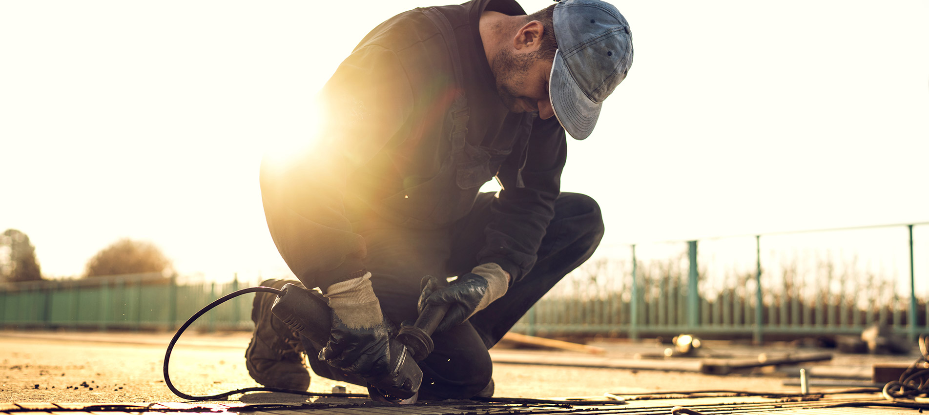 Construction Worker On Road Maintenance At Sunset