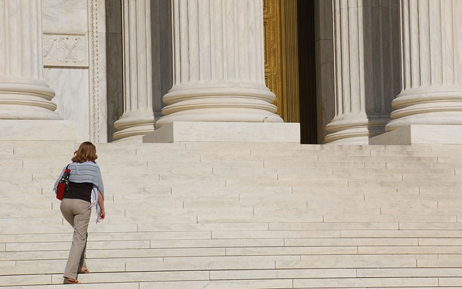Woman Walking Up Steps Of US Supreme Court