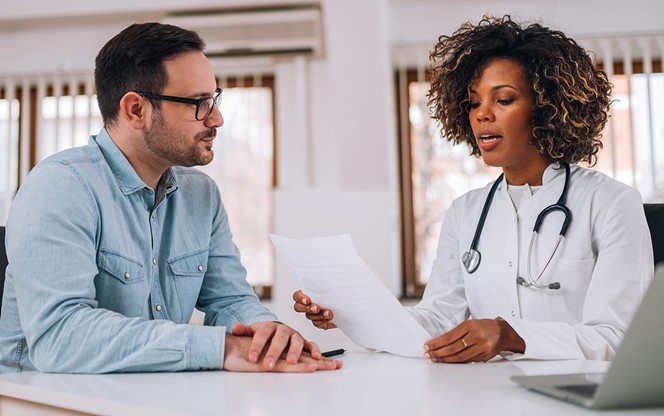 Doctor Talking To A Patient At Medical Clinic