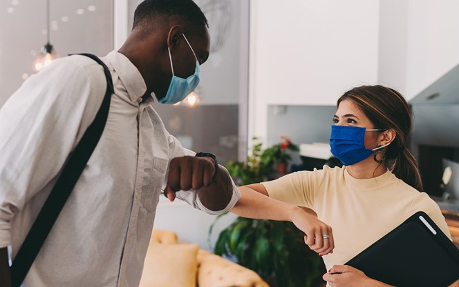 Business People Greeting With Elbow Bump During COVID 19 Pandemic