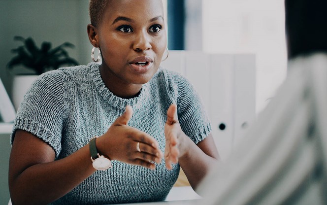 Woman Having A Discussion With A Colleague