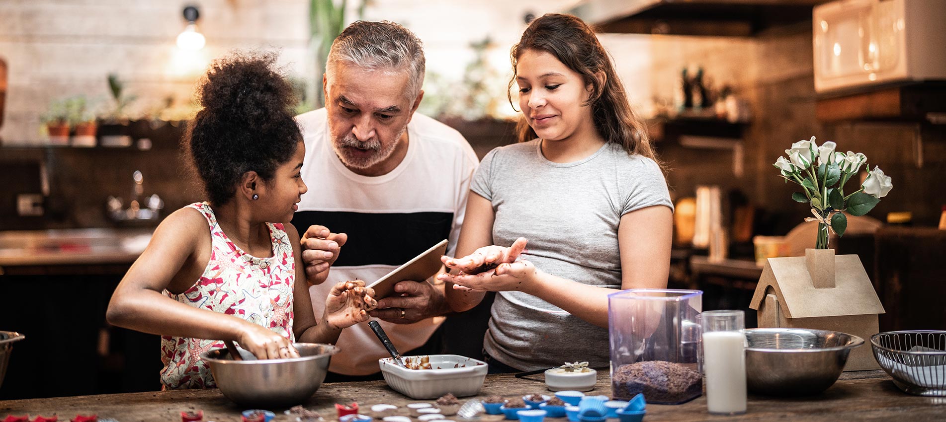 Grandfather Teaching Their Grandchild How To Prepare Brazilian Brigadeiro
