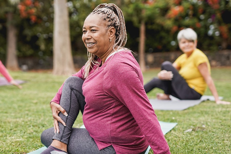 Multiracial Women Doing Yoga Exercise With Social Distance For Coronavirus Outbreak At Park Outdoor