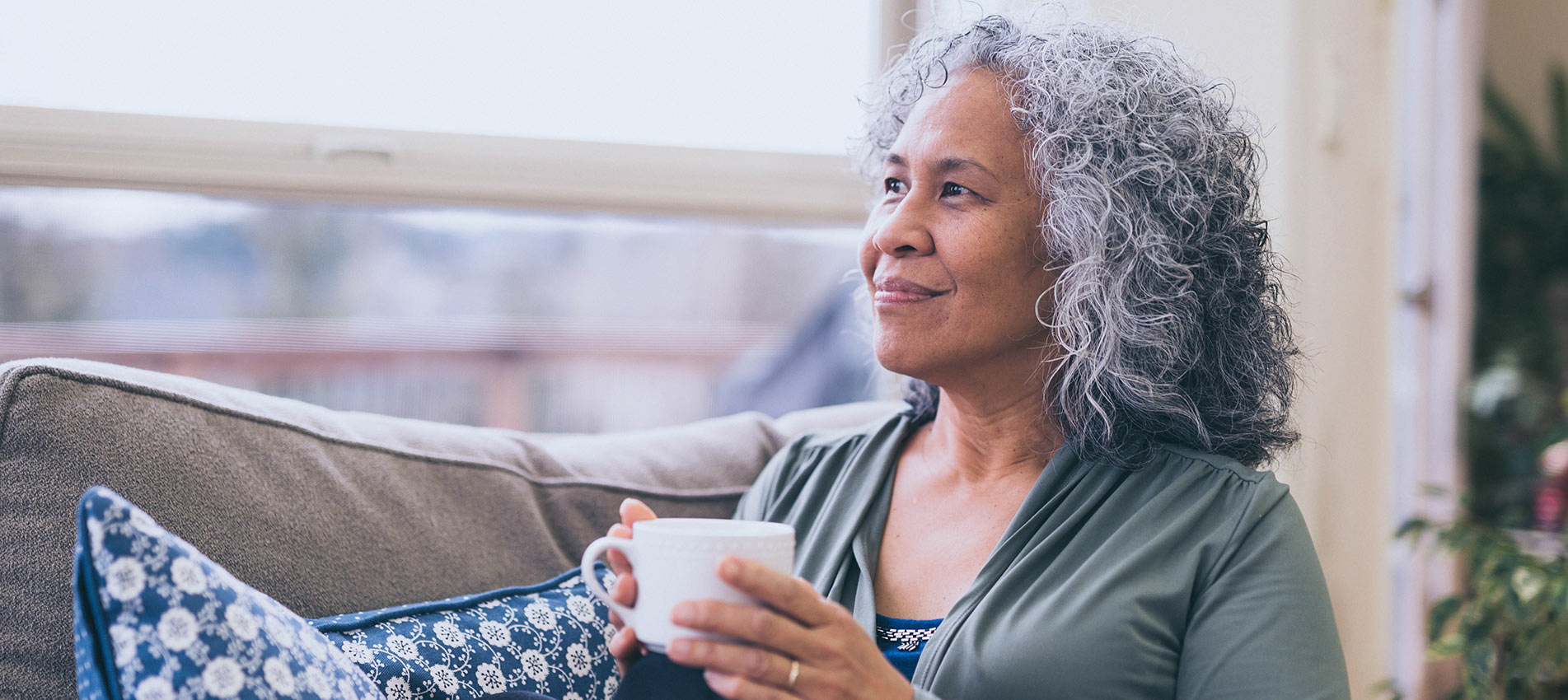Mature Hawaiian Woman In The Early Morning With A Cup Of Tea And Contemplates The Day Ahead