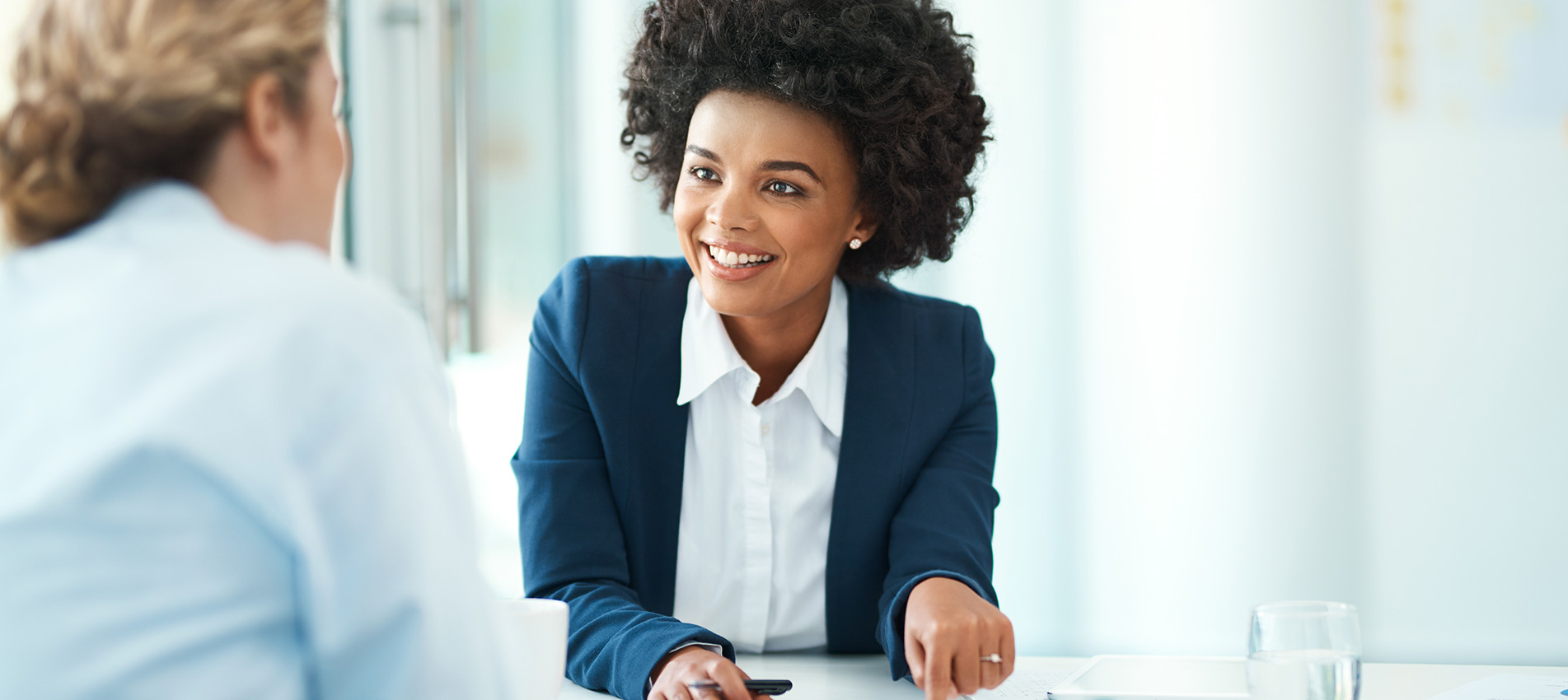 Professional African American Businesswoman Smiling Talking To A Client