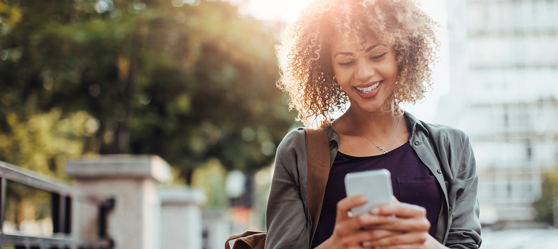 Young Smiling Woman Using A Smart Phone