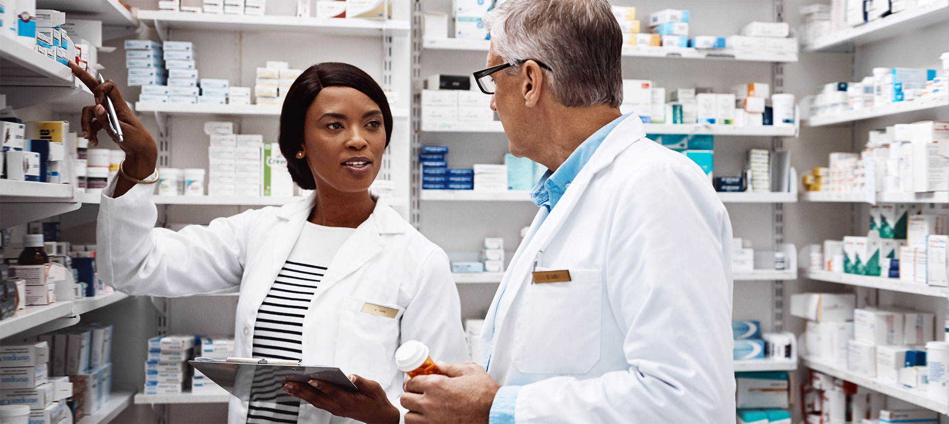 Two Pharmacists Working Together In A Drugstore