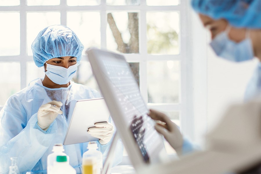 Scientists Wearing Full Protective Suit Working In The Laboratory