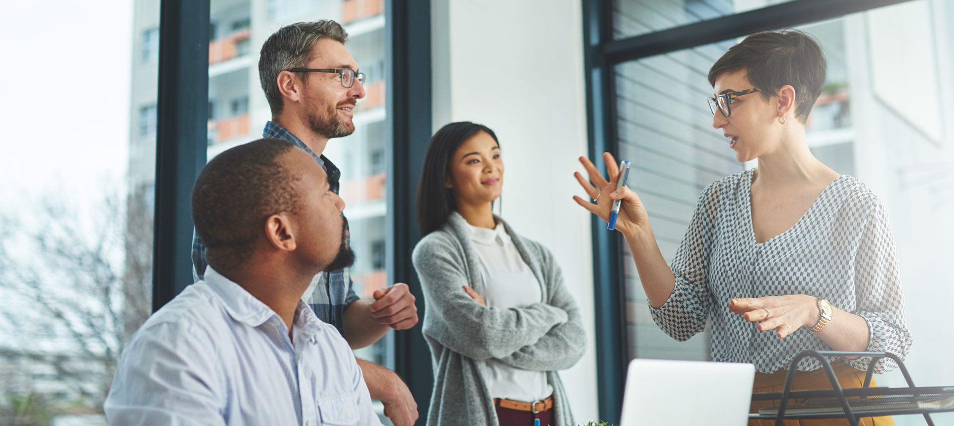 Group Of Colleagues Having A Discussion In A Modern Office