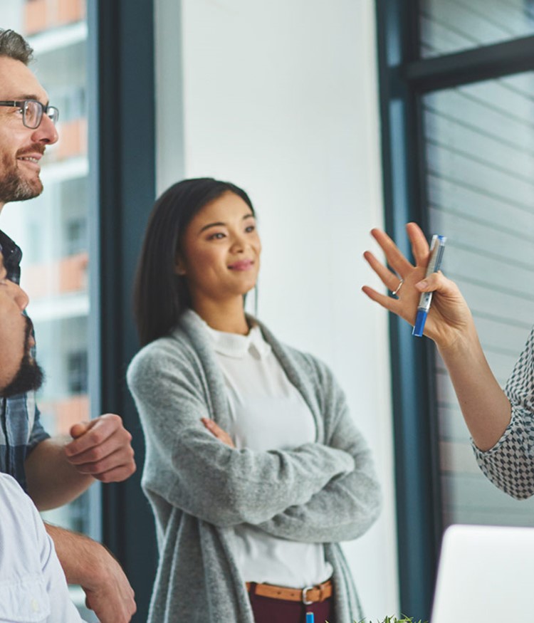 Group Of Colleagues Having A Discussion In A Modern Office