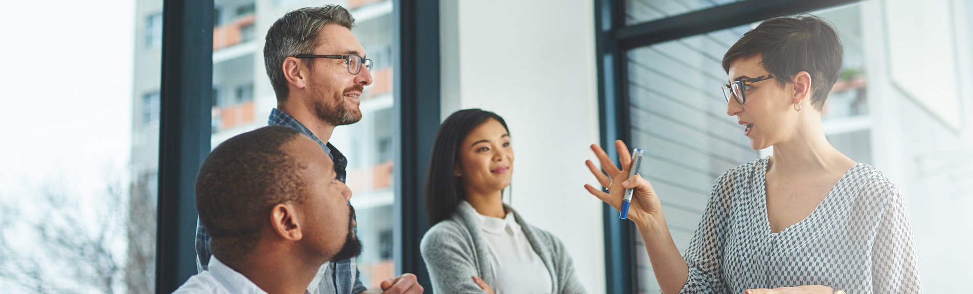 Group Of Colleagues Having A Discussion In A Modern Office