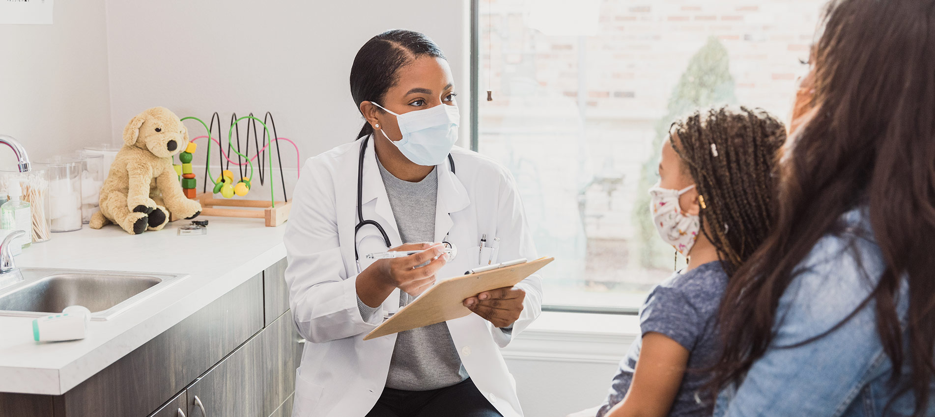 Female Pediatrician Talks With Patients Mother