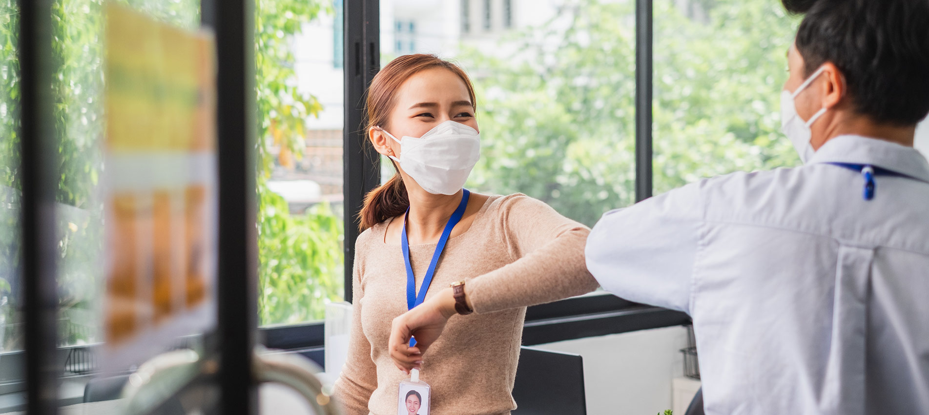 Asian Businesswoman Greeting With Elbow Bump