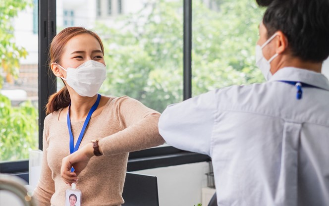 Asian Businesswoman Greeting With Elbow Bump