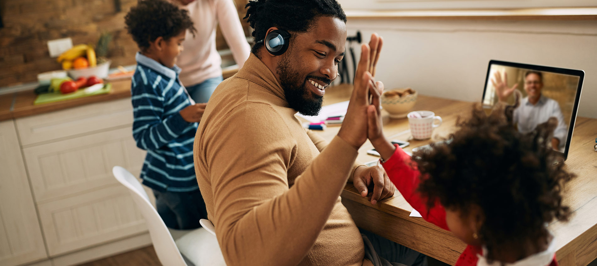 Happy Black Father Giving High Five To His Daughter While Working At Home