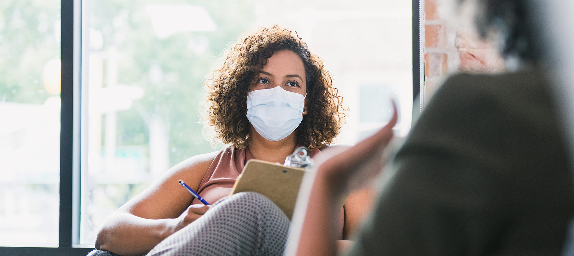 Female Counselor Wears Mask During Session