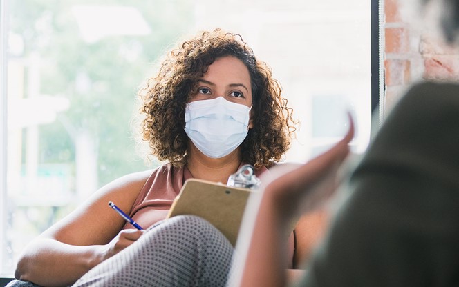 Female Counselor Wears Mask During Session