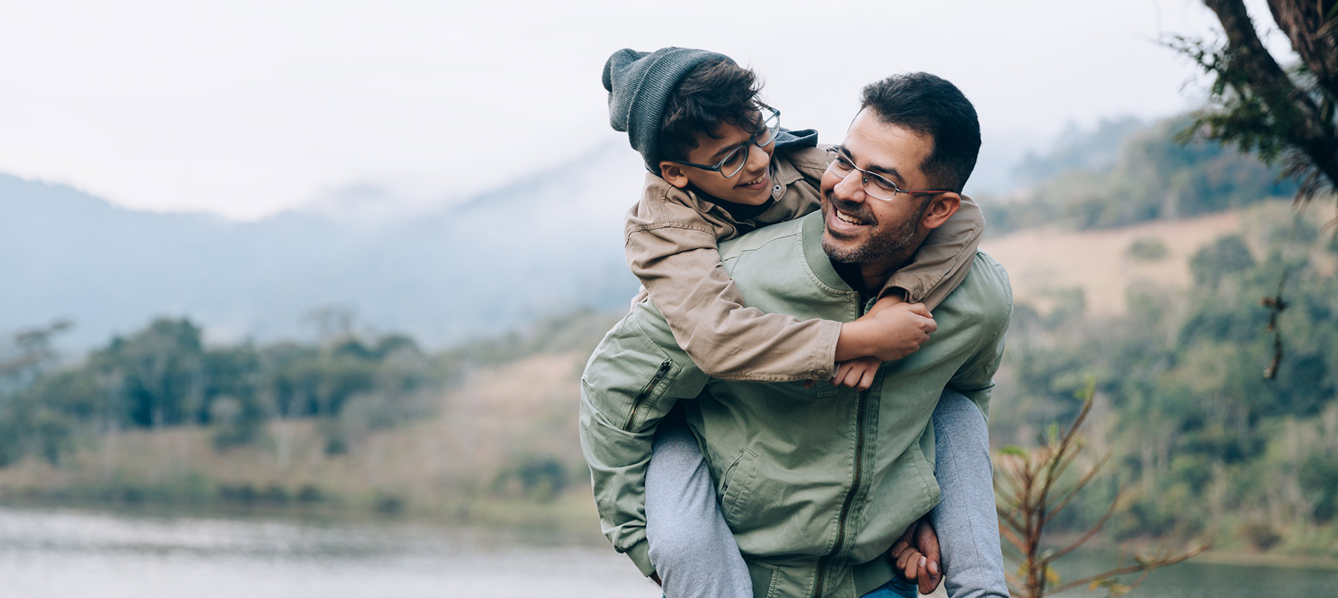 Father Carrying Son On His Back