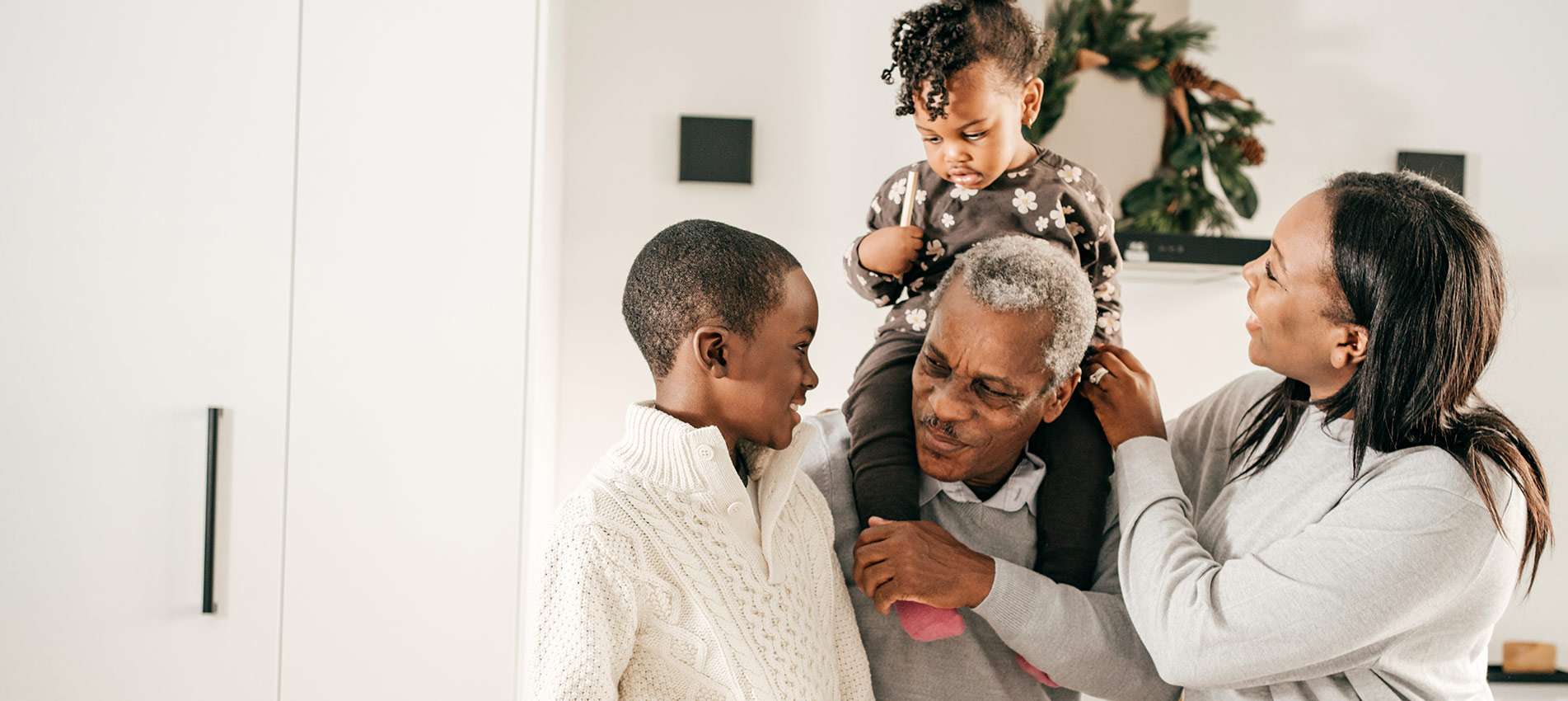 African American Family Visiting Grandad With Kids