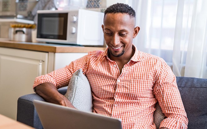 Afro Latino Men Working On A Laptop At Home