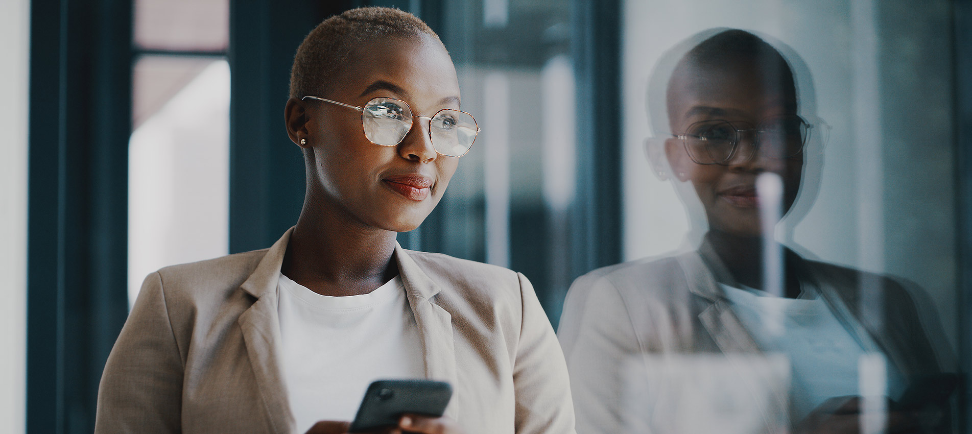 Young African American Businesswoman At The Office With Her Phone