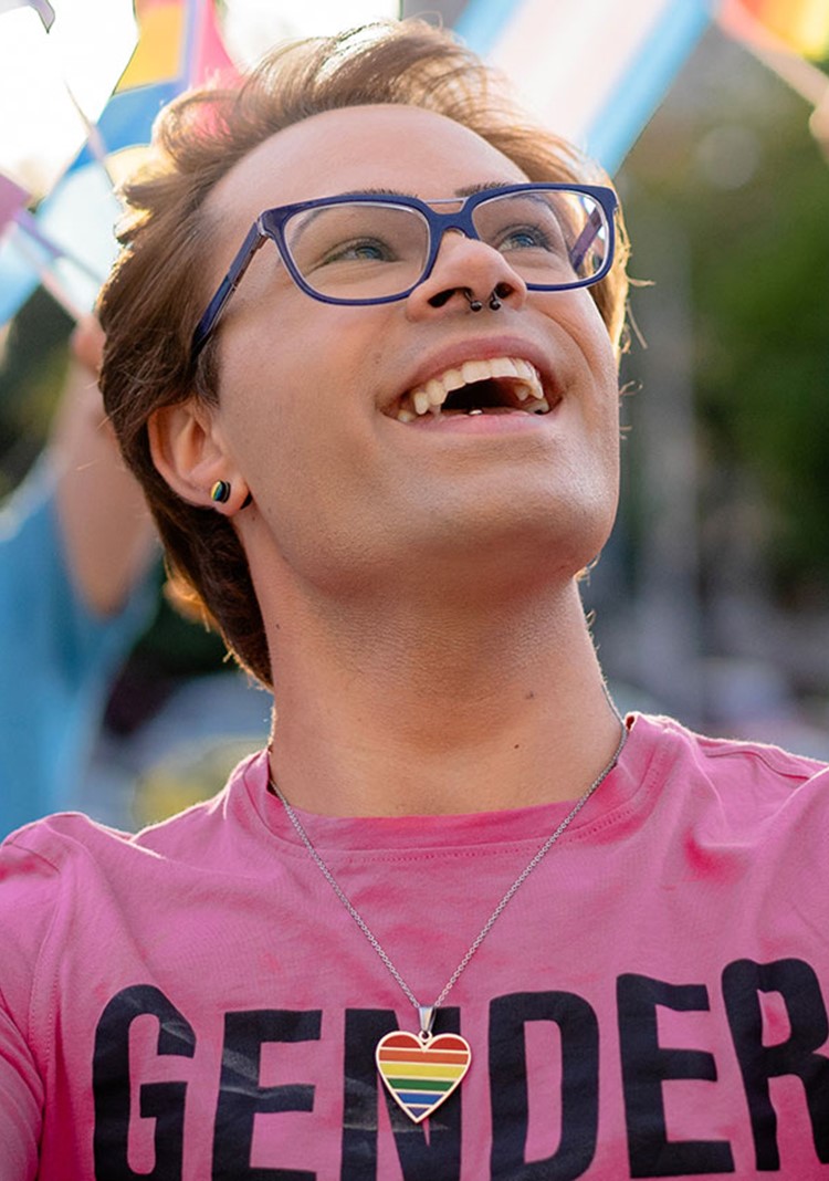 Transgender Activist Holding Lgbtqi Flags In His Hands And Looking Up To The Sky